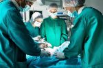 Transsphenoidal surgery \ Cushing's Disease News \ A stock photo of a surgeon and other medical personnel in the operating room performing surgery on a patient