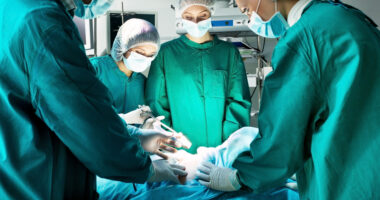 Transsphenoidal surgery \ Cushing's Disease News \ A stock photo of a surgeon and other medical personnel in the operating room performing surgery on a patient