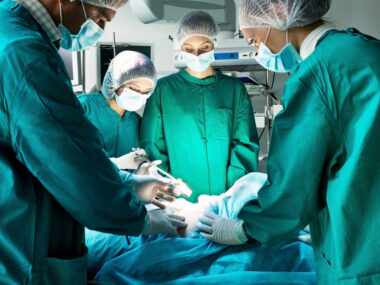 Transsphenoidal surgery \ Cushing's Disease News \ A stock photo of a surgeon and other medical personnel in the operating room performing surgery on a patient