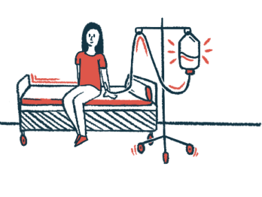 A woman sits on a bed while receiving an IV infusion.