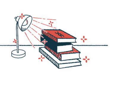 A desk lamp shines its light on a pile of books on a table.