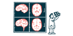 A doctor looks at an X-ray while four images of a brain are projected on a screen.