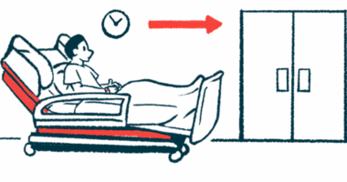 A patient sits in a hospital bed in a hallway near a set of closed double doors.