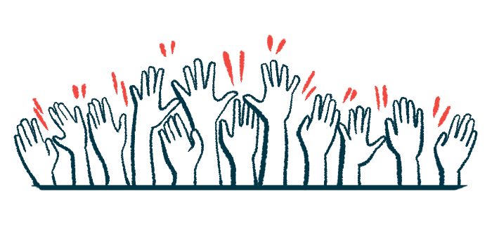 Multiple hands are seen raised in the air.